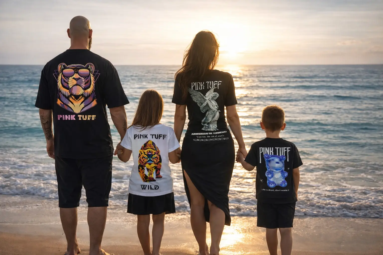 Happy family on the beach wearing pinktuff